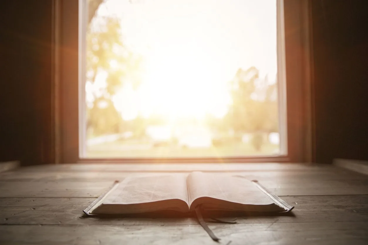 Open Bible by a bright window