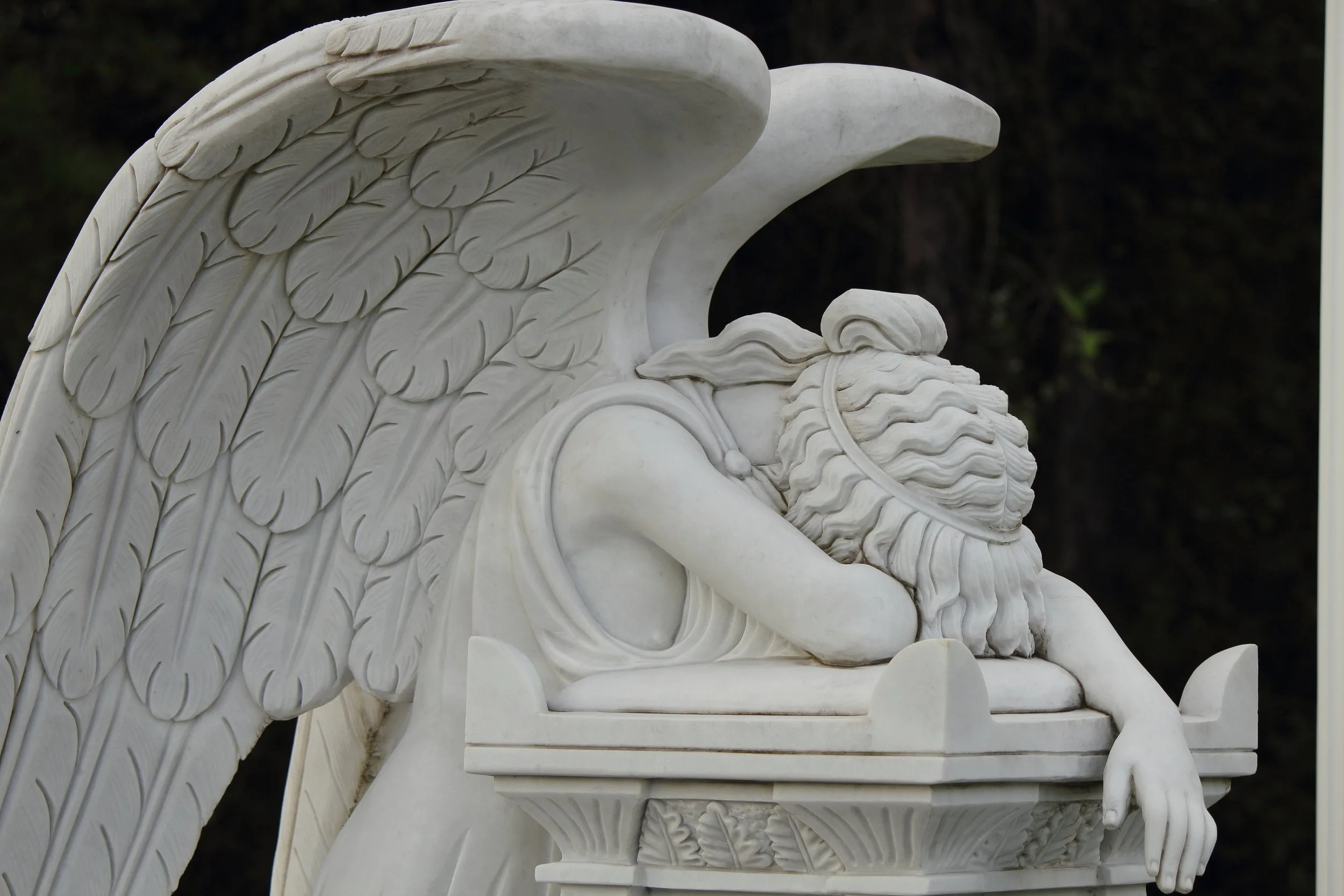 Anguished figure kneeling in shadow