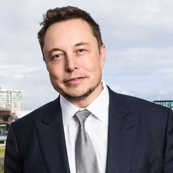 Student reading beside a stack of books