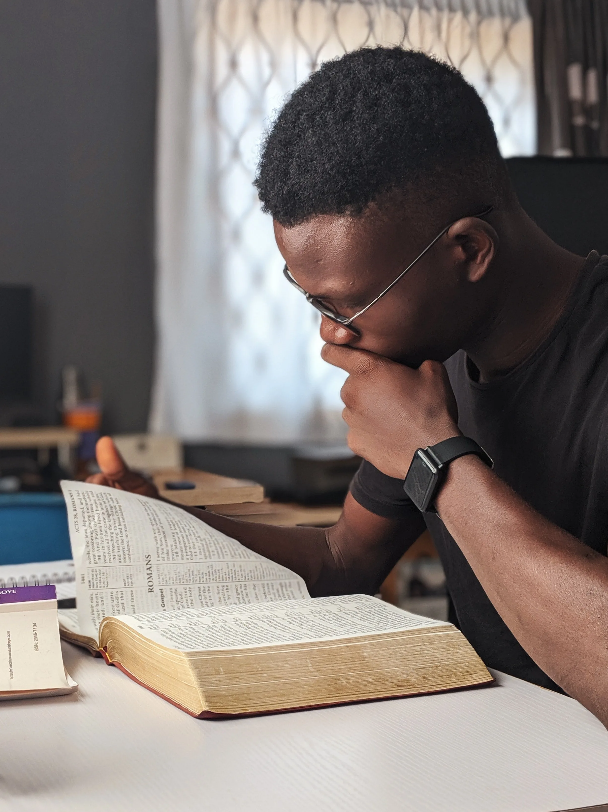 Man reading the Bible at a desk